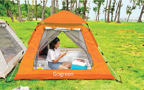 Lady having a fun time camping over at St John Island in a tent with Gogreen